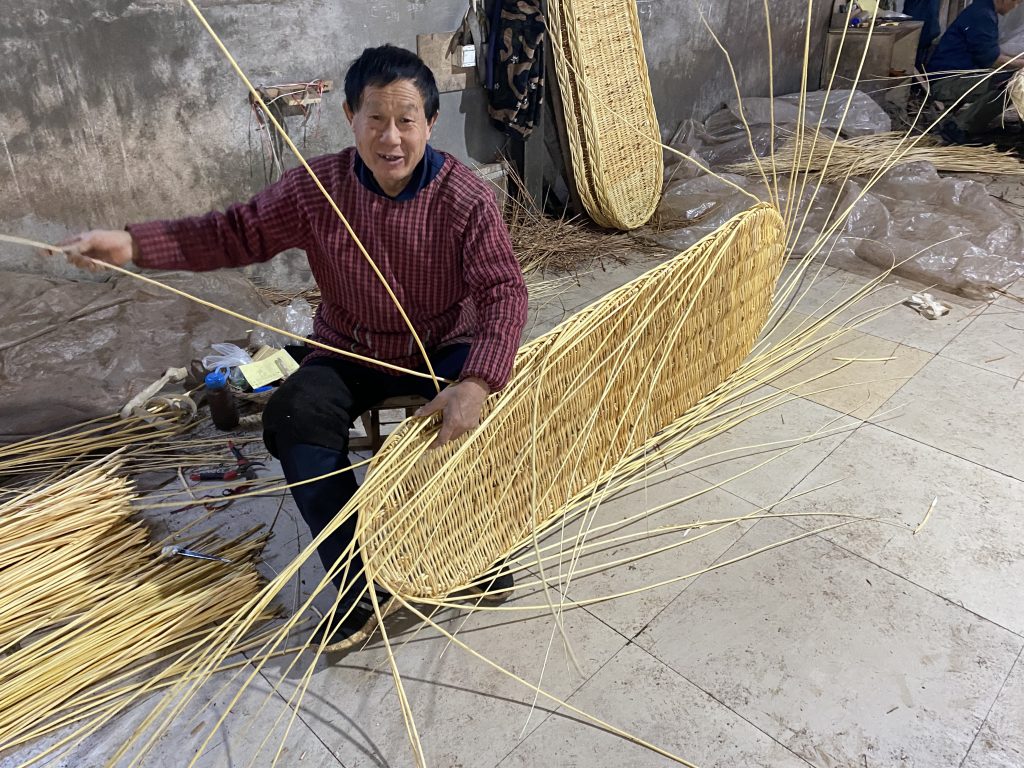 Willow coffin frame being hand-woven by an experienced craftsperson